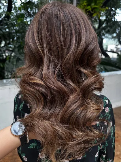 This is my signature 'Caramello' color. It features warm caramel highlights woven through a brunette base for a sweet, sun-kissed look.