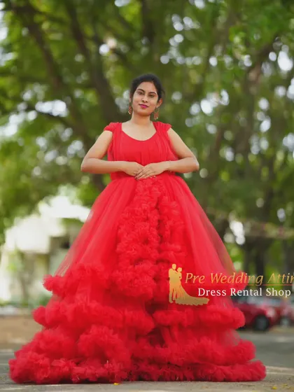 A front-on view of the red ruffled gown, showing the full cascade of ruffles down the skirt.