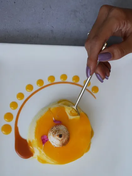 A mango panna cotta with a meringue kiss. An elegant and artistic dessert to end your meal.