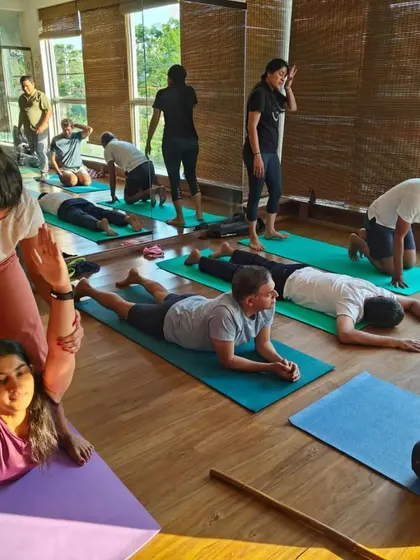 Another view of an assisted backbend, this time helping a student with a deeper variation. Partner work allows for exploration of advanced postures with an added layer of safety and support.