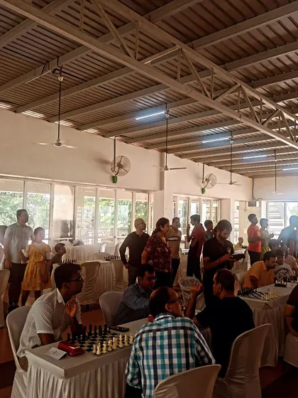 The tournament is in full swing at a community clubhouse. We use the Swiss format to ensure that players are matched with opponents of similar skill levels throughout the event.