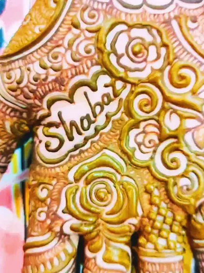 A close-up of the groom's name, 'Shabaz', written on the bride Daniya's palm. It's all in the details.