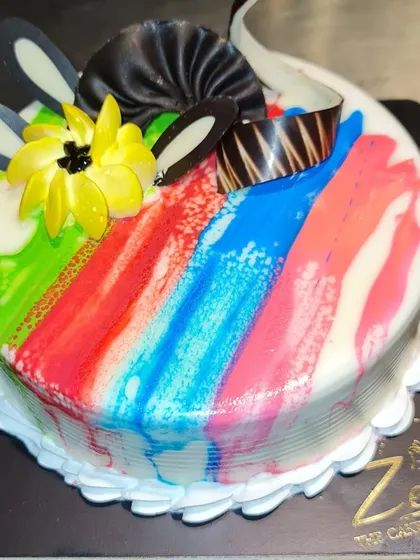 A colorful very berry cake with a rainbow brushstroke design. This cake is as fun to look at as it is to eat.