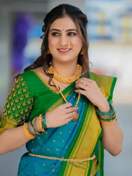 A candid moment of the bride adjusting her necklace. The makeup is designed to look flawless from every angle.