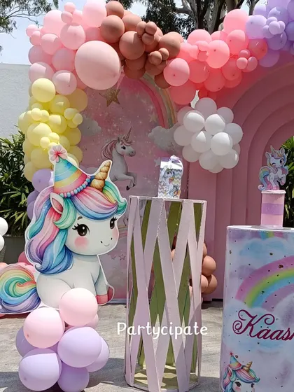 A close-up of the cute unicorn cutout and themed pedestals from Kashni's party. The pastel rainbow colors were used throughout the decor for a cohesive look.