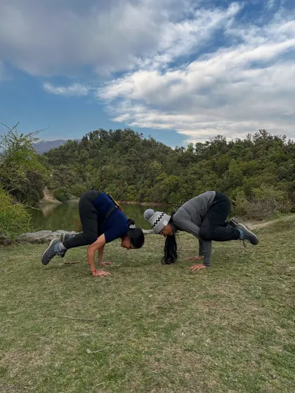Partner practice of Bakasana, or crow pose, with a friend on the trail. This arm balance requires trust and focus, and practicing it together in the fresh mountain air was a fun challenge.