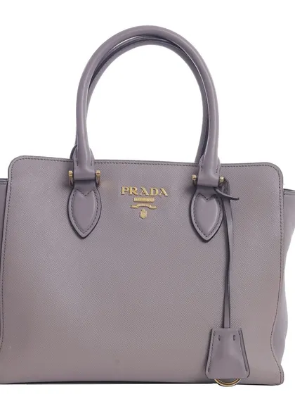 A clean, front-facing product shot of a Prada handbag against a white background, the standard for any professional e-commerce catalog.