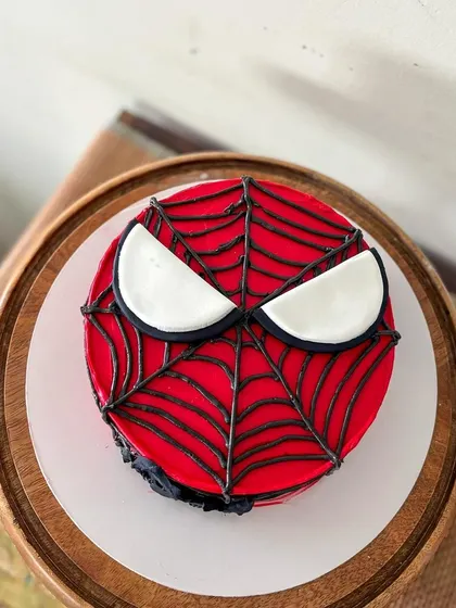 A top-down view of the Spider-Man bento cake, showing the fondant eyes.