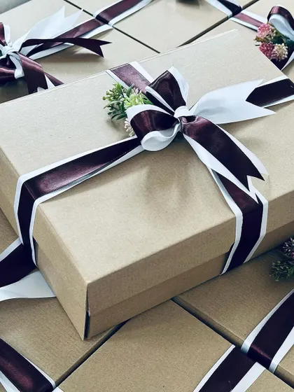 A close-up of a corporate gift box, highlighting the elegant ribbon work and the quality of the packaging.