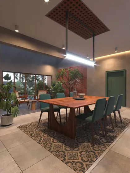 A dining room in an Ernakulam project featuring a unique suspended ceiling panel over the table. The space opens to a patio and uses traditional patterned tiles to define the area.