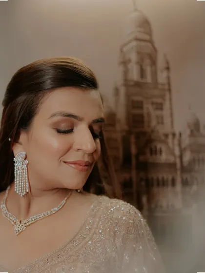 A beautiful close-up of Vrinda, with a portrait of Mumbai's iconic architecture in the background, rooting her story in her city.