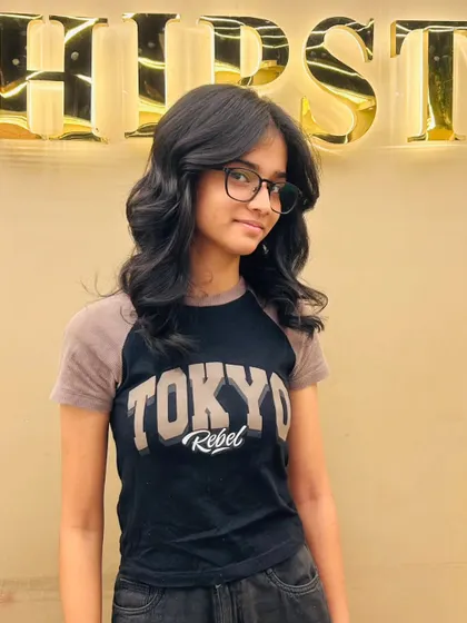 A happy client with her new layered haircut, a style that is both trendy and timeless.