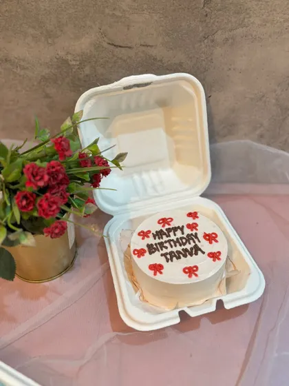 A cute birthday bento cake for Tanya, decorated with little red bows.