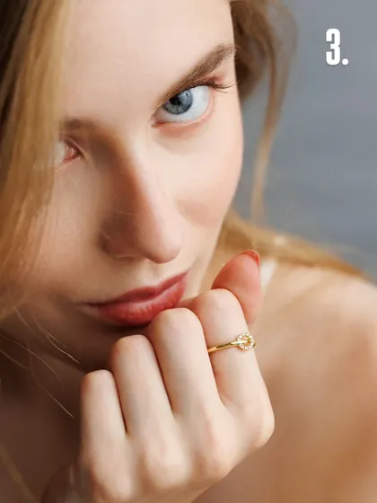 A direct, confident gaze paired with a simple hand gesture makes this ring feel modern and chic. The clean lighting and sharp focus are hallmarks of our controlled approach to beauty and jewellery photography.