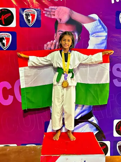 A young student stands proudly on the first-place podium, representing India at an international event. This is an inspiring achievement for our entire academy.