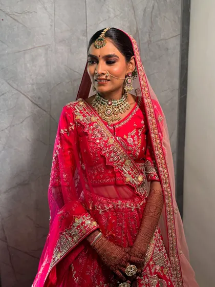 A three-quarter profile of my bride, showing the seamless blend of her makeup and the way her dupatta is draped to frame her face beautifully.