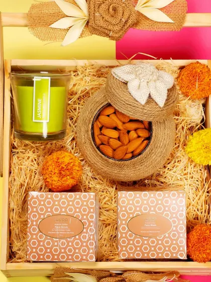 A detailed close-up of the face scrub and mask products within the gift hamper, focusing on the packaging.
