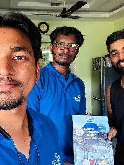 Our team takes a selfie with a customer and his new solar booklet.