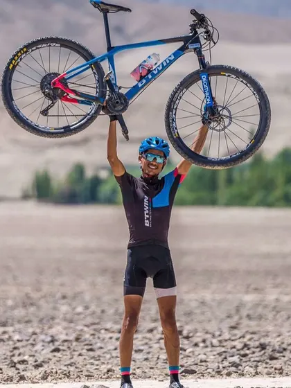 A rider with his Btwin Rockrider mountain bike, perfectly at home in the rugged, off-road terrain. This is what shredding the trails looks like.