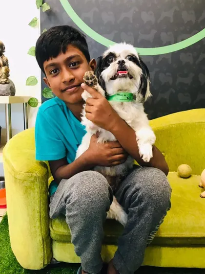 Hira the Shih Tzu sharing a happy moment with his young human. We welcome pet lovers of all ages to our salon.