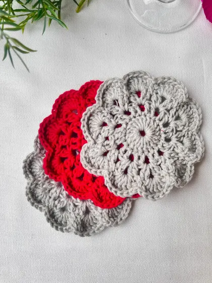 A lovely set of three mandala coasters in grey and red. This color combination is a popular choice for a modern yet warm home decor style.
