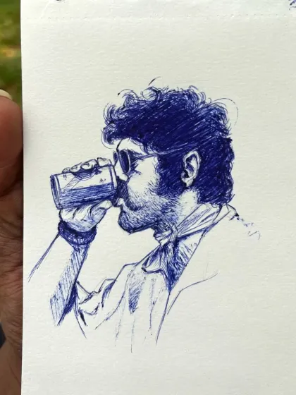 Holding up the finished pen and ink sketch. This shows the scale of the drawing and how it looks as a physical piece of art, straight from the sketchbook.