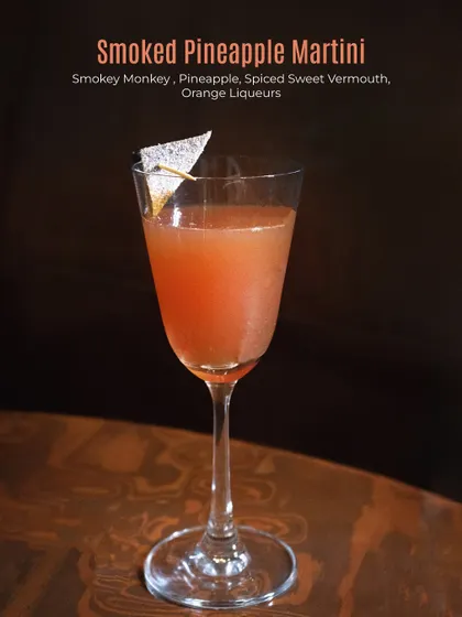 The Smoked Pineapple Martini, a complex drink with smoky whisky and sweet pineapple.