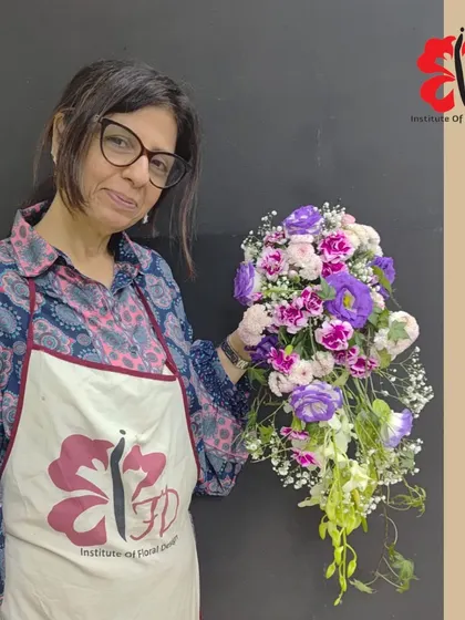 This student created a vibrant cascading bouquet with purple lisianthus and pink carnations. Learning to combine bold colors is a key part of our curriculum on color theory in floral design.