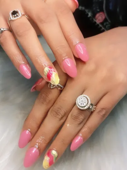 A bright and cheerful pink manicure with a colorful abstract accent nail. This is a great way to add a pop of personality to a classic look.