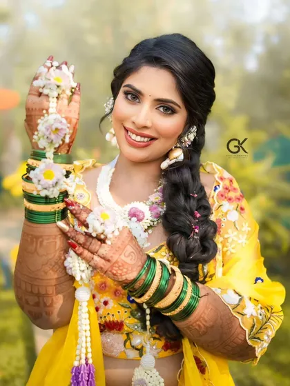 A radiant bride showing off her complete Haldi look. We designed this fresh floral set with kalire to match her bright yellow lehenga, creating a cheerful and traditional vibe.