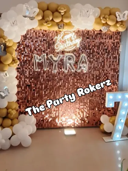 A wider view of the 7th birthday setup, showing how the balloon arch frames the sequin backdrop and marquee number, creating a complete and cohesive look.