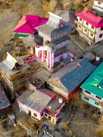 An aerial view highlighting the colorful and distinct architecture of the Jai Ishwari Maa Temple in Dharech. Drone photography allows for these incredible, detailed views.