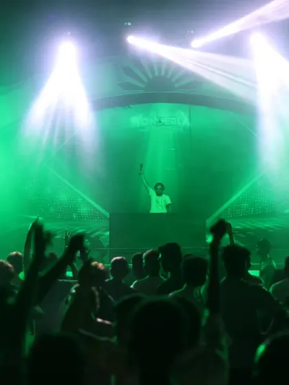 A closer view of the stage, with the crowd's hands raised in excitement.