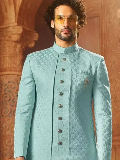 This light blue Indo-Western sherwani has a subtle texture and a modern cut. It's a sophisticated choice for a day wedding or an engagement ceremony.