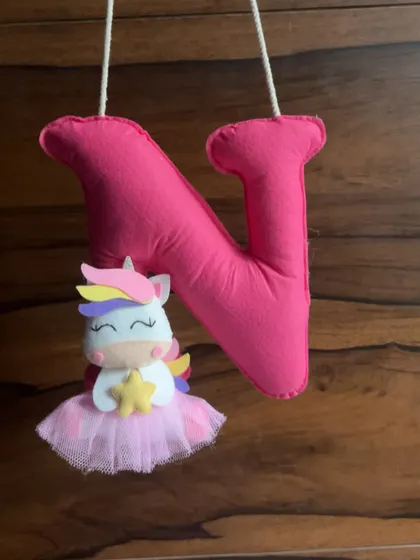 A custom-made felt initial "N" with a unicorn, a sweet decorative piece from Nidhi's first Rakhi hamper.
