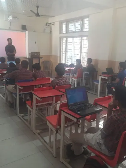 Students use their laptops to participate in practical exercises during the cybersecurity workshop.