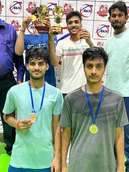 Celebrating a doubles victory. These players are holding their trophies and medals, showcasing the teamwork and coordination we develop in our training.