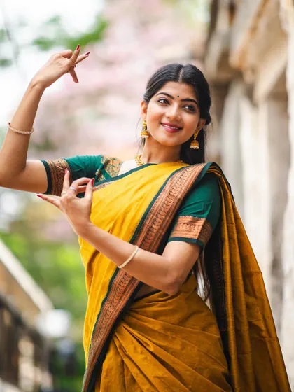 A close up from the 'Manjal' saree shoot, focusing on the hand gestures, or 'mudras', of Bharatanatyam. Every detail, from the expression to the fingertips, tells a story.
