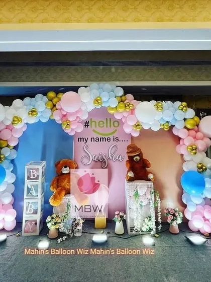 A full view of the naming ceremony stage, showing the personalized backdrop and adorable teddy bear props.