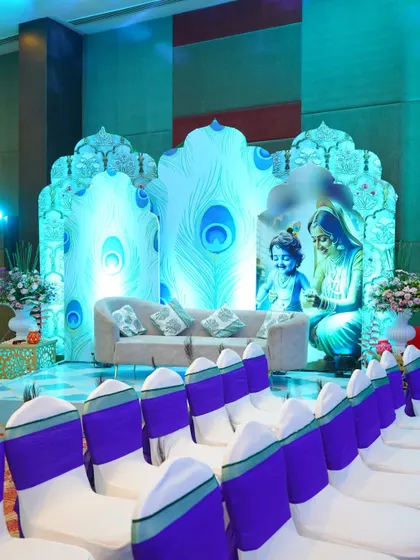 Celebrating a new life with a divine touch. For this baby shower, I designed a custom stage inspired by Lord Krishna, using peacock feather motifs and soft blue lighting to create a serene and blessed atmosphere for the family.