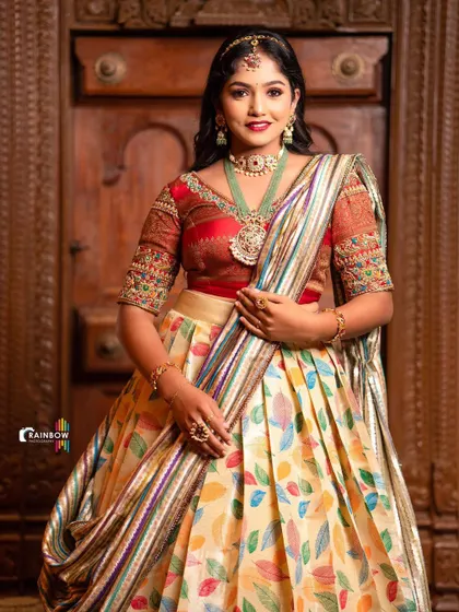 A medium shot of the model, highlighting the beautiful drape of the dupatta and the colorful skirt.