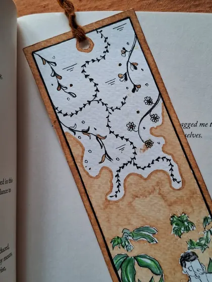 A detailed shot of the floral and abstract patterns on a custom bookmark. I enjoy mixing organic shapes with the unpredictable nature of coffee stains.