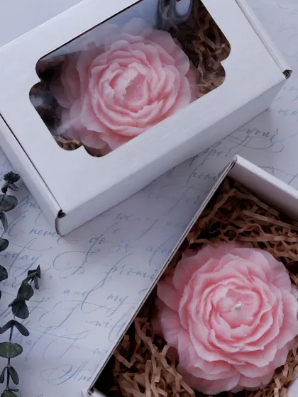 A pink peony candle, boxed and ready to be gifted. The color is soft and romantic, perfect for a special someone.