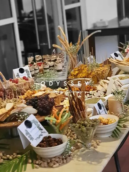 We love assembling diverse flavors on one table. This grazing setup features a mix of savory bites, dips, breadsticks, and nuts, all labeled and arranged to create a special, central moment for guests to gather.