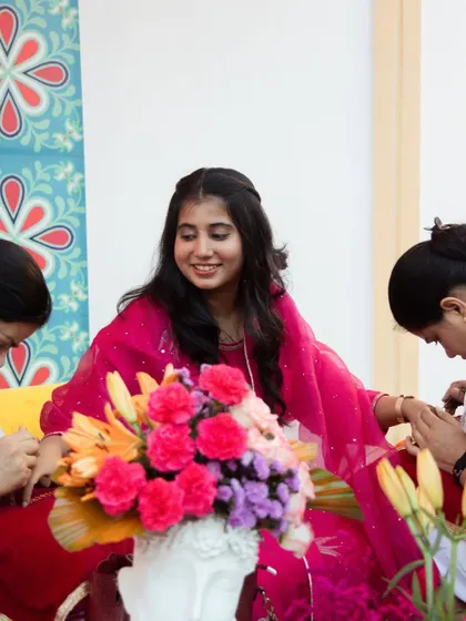 A candid moment of a guest enjoying the Mehendi application. We create a relaxed and festive atmosphere for everyone to enjoy the traditions.