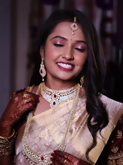 This close-up shows the details of the eye makeup and how it complements her beautiful ruby and diamond necklace.