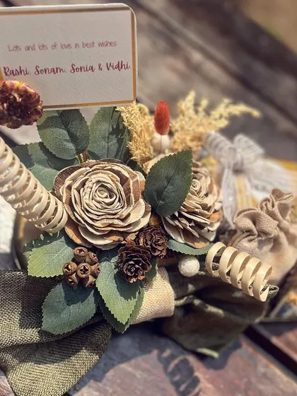 A detailed shot of the platter, showing the personalized card and the arrangement of natural, earthy elements that give it a warm and artisanal feel.