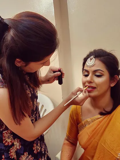 A quiet moment behind the scenes, perfecting the lip color for this stunning bride. My focus is always on the small details that bring the entire look together.