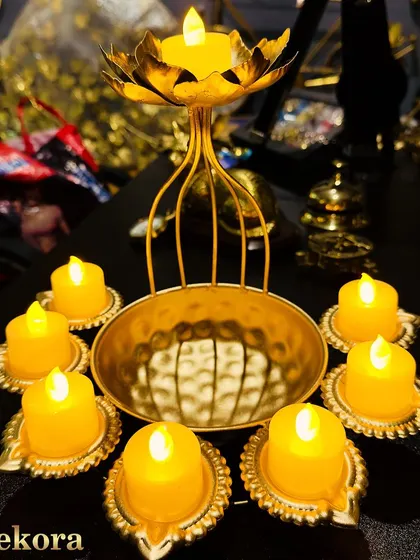 This elegant centerpiece combines a central urli bowl with an elevated lotus T-light holder, surrounded by individual electric diyas. It's a complete, safe, and reusable decor solution for any corporate setting.