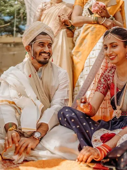 The couple shares a smile during their Kannada wedding ceremony, a candid moment of connection.